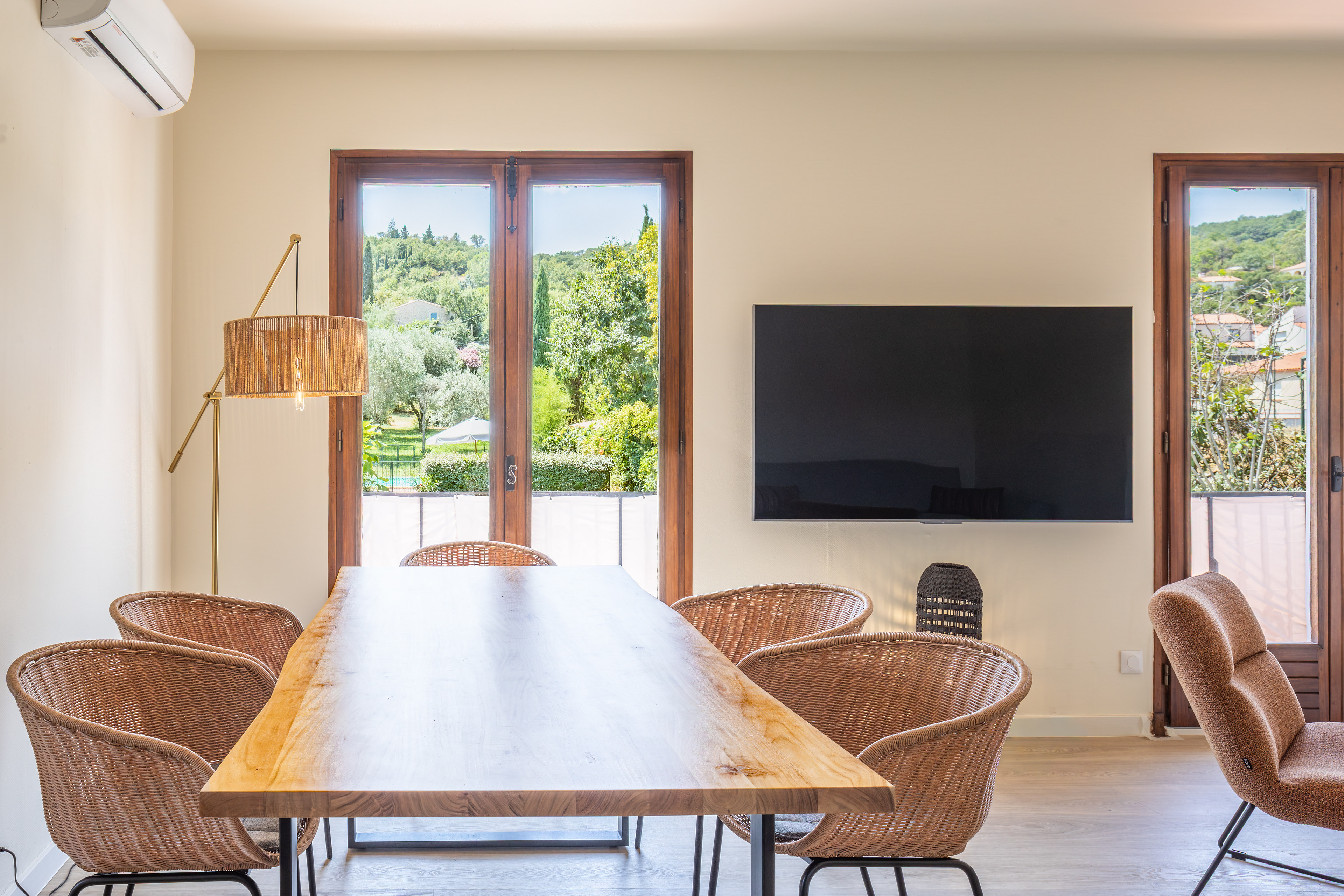 Esstisch von Alosa Balcon mit Fernseher und Türen zur Terrasse