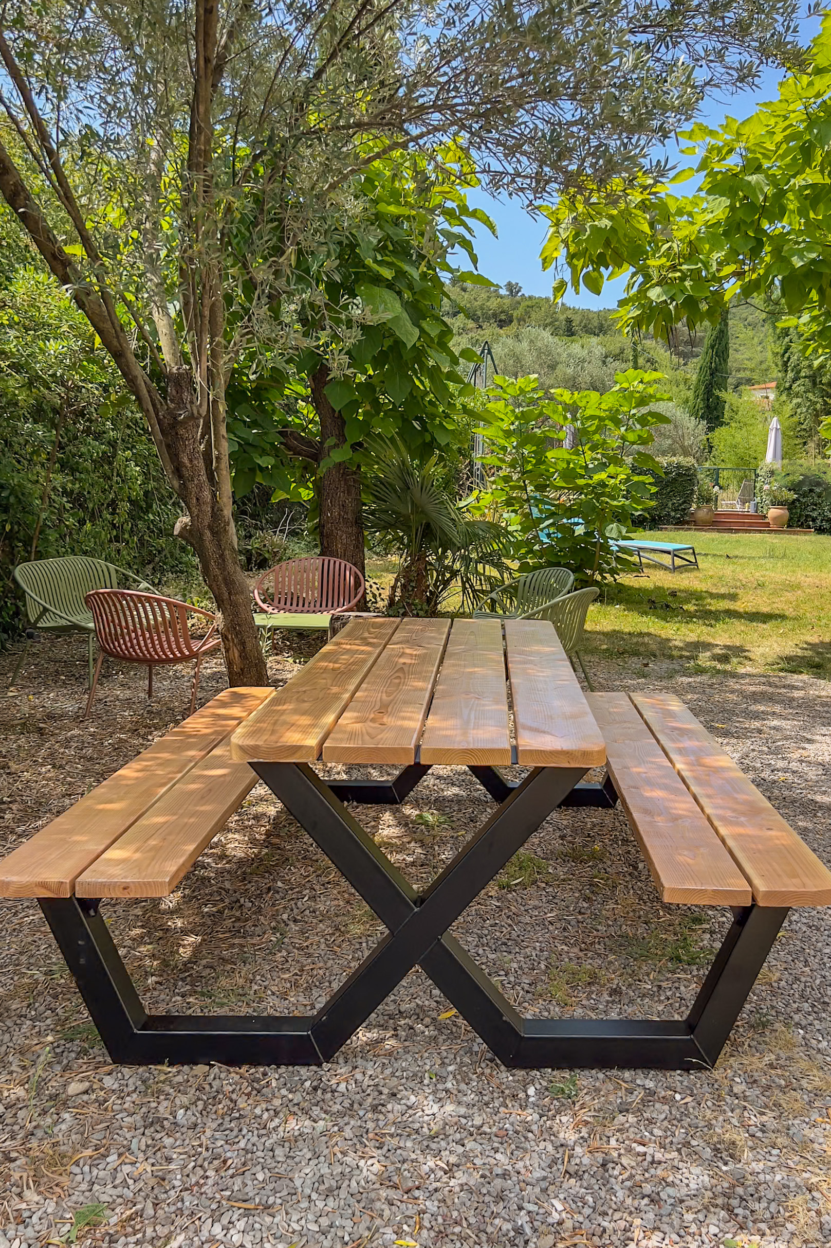 Picknicktisch aus Holz in einer schattigen Ecke des Gartens